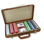 A TRAVELLING POKER SET Including two decks of playing cards and chips, contained in a brown