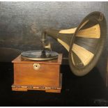 A BYEGONE MAHOGANY TABLE TOP WIND UP GRAMOPHONE With painted horn. (30cm x 29cm x 50cm)