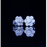 A PAIR OF 18CT WHITE GOLD AND 2CT DIAMOND DAISY CLUSTER EARRINGS The arrangement of round cut