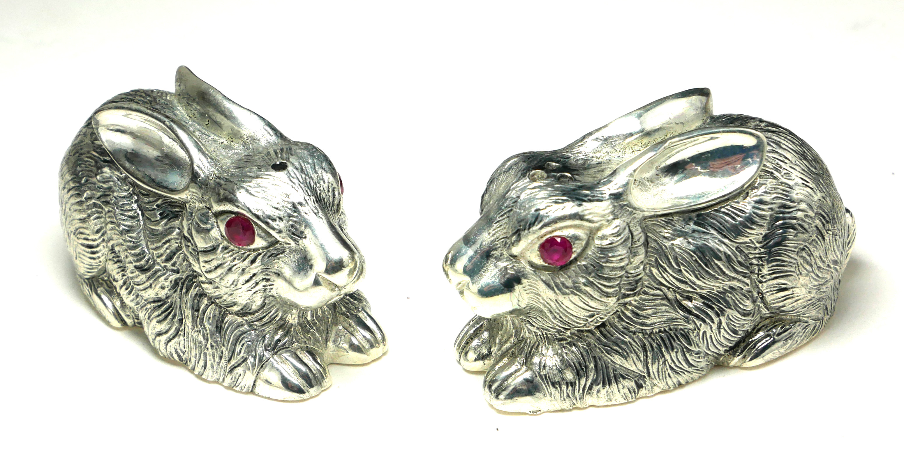 A PAIR OF CONTINENTAL SILVER 'RABBIT' SALT AND PEPPER POTS Having engraved decoration and glass