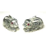 A PAIR OF CONTINENTAL SILVER 'RABBIT' SALT AND PEPPER POTS Having engraved decoration and glass