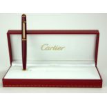 CARTIER, A CASEDFULL SIZE GOLD PLATED STYLO DIABOLO BALLPOINT PEN Bordeaux finish with cabochon