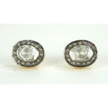 A PAIR OF CONTINENTAL SILVER GILT AND DIAMOND OVAL EARRINGS With rough cut diamond, edged with