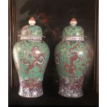 A LARGE PAIR OF CHINESE MING STYLE VASES AND COVERS Decorated with dragons amongst clouds on a