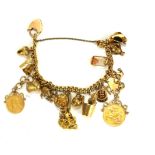 A VICTORIAN YELLOW METAL, 9CT GOLD AND 22CT GOLD CHARM BRACELET The yellow metal Albert link