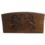 AN OAK PANEL CARVED WITH A COAT OF ARMS. (97cm x 52cm)