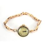 AN EARLY 20TH CENTURY 9CT GOLD LADIES' COCKTAIL WATCH Gold tone dial with expandable gold bracelet