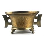 A CHINESE POLISHED BRONZE TWO HANDLED CENSOR With flared rim and engraved decoration in the form