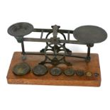 SAMPSON MORDAN, A LARGE SET OF VICTORIAN OAK AND BRASS POSTAL SCALES Set with eight brass weights (