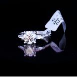 AN 18CT WHITE GOLD AND 1.59CT DIAMOND RING Having a central round cut diamond with baguette cut