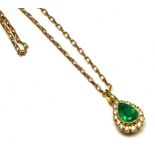 AN 18CT GOLD, EMERALD AND DIAMOND CLUSTER PENDANT The pear cut stone edged with round cut