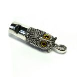 A SILVER NOVELTY OWL FORM WHISTLE Having embossed detail with paste set eyes. (approx 4cm)