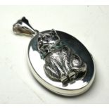 A SILVER 'CAT' NOVELTY PENDANT LOCKET Having an applied cat with glass eyes and collar. (approx 3.