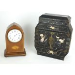 AN EDWARDIAN MAHOGANY BEDROOM CLOCK Having a circular white dial with a Sheraton inlaid shell to