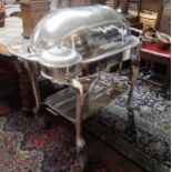 A SILVER PLATED BAIN MARIE The roll top enclosing a fitted interior above a two handled serving