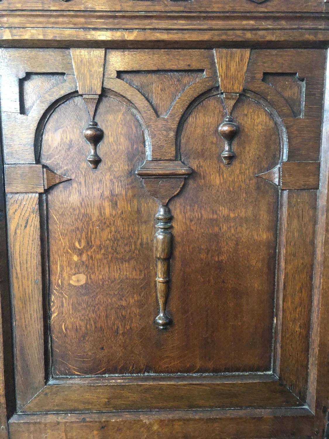 AN ANTIQUE OAK CUPBOARD With carved arcaded frieze above two panelled doors applied with - Image 3 of 4
