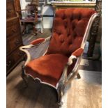 A VICTORIAN BLEACHED WALNUT SCROLL BACK OPEN ARMCHAIR Button back salmon pink upholstery, with
