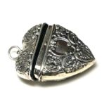 A SILVER NOVELTY HEART FORM LOCKET/CASE Having embossed decoration and pendant loop. (approx 4cm)