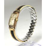 GRUEN, AN EARLY 20TH CENTURY YELLOW METAL WRISTWATCH Rectangular dial, convex glass, on bracelet