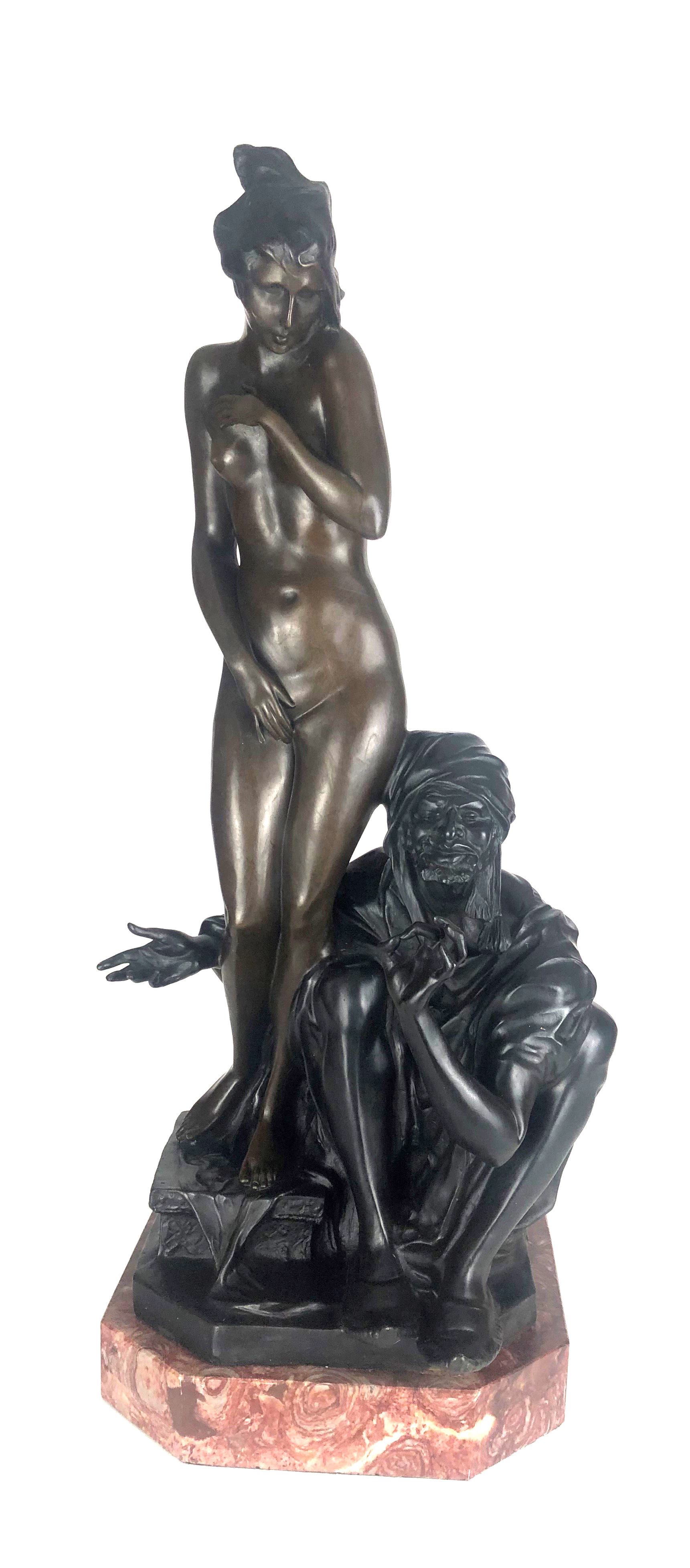 AN ART NOVEAU STYLE BRONZE STATUE OF A NUDE SLAVE GIRL WITH HER MASTER On rouge marble base. (