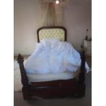 A LARGE VICTORIAN MAHOGANY SINGLE BED With barley twist supports, draped canopy above upholstered