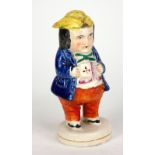 STAFFORDSHIRE, A 19TH CENTURY POTTERY FIGURAL PEPPER POT MODELLED AS TOBY PHILPOT With yellow bicorn