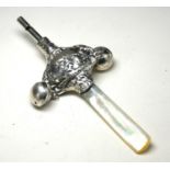 A SILVER AND MOTHER OF PEARL 'NURSERY RHYME' CHILD'S RATTLE Embossed decoration marked 'Hey Diddle