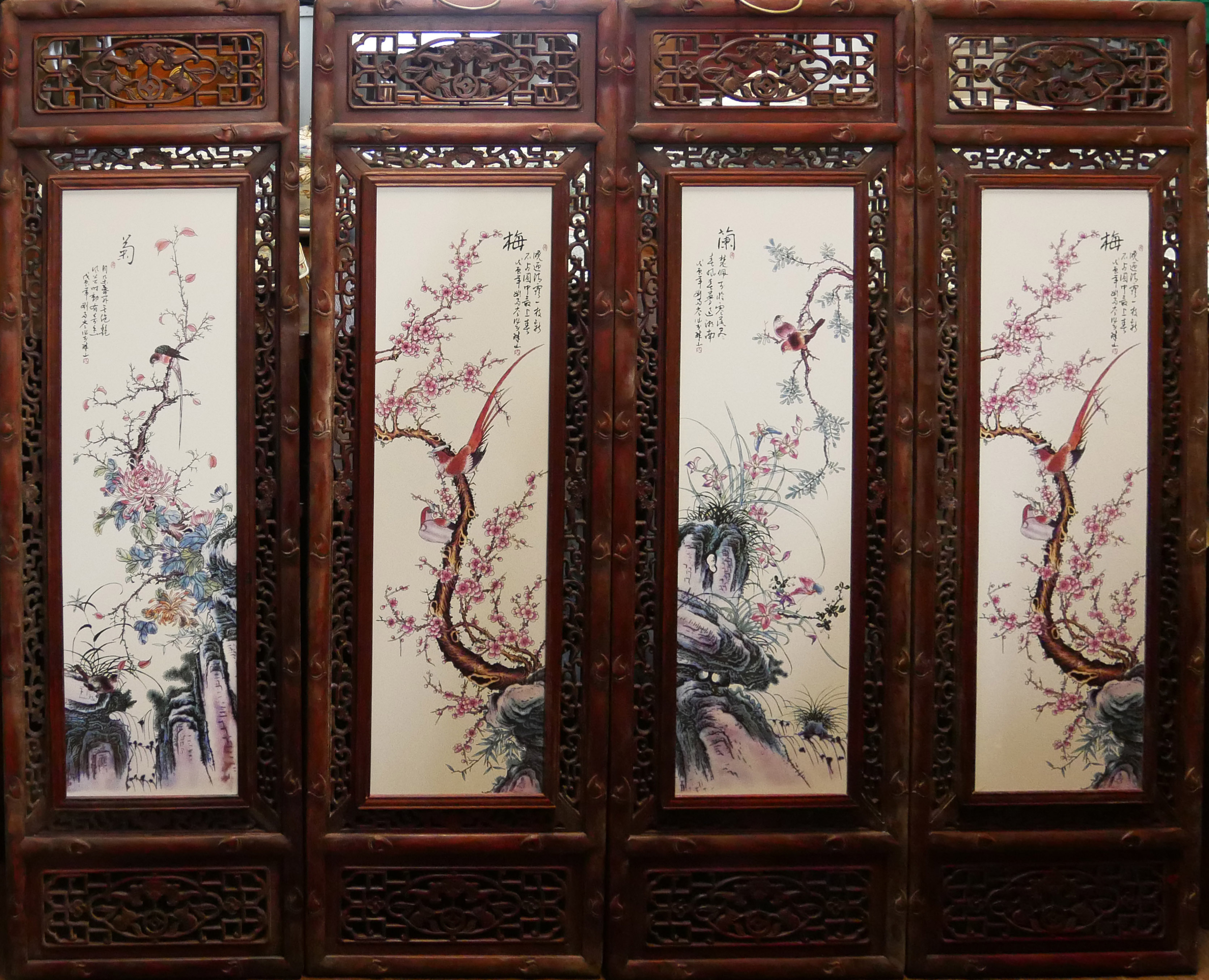 A SET OF FOUR CHINESE PORCELAIN PLAQUES Decorated with birds amongst flora, in a decorative