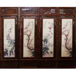 A SET OF FOUR CHINESE PORCELAIN PLAQUES Decorated with birds amongst flora, in a decorative