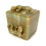 A CHINESE JADE BOX AND COVER CARVED WITH CHI DRAGONS With chamfered edges. (8cm x 7.5cm x 9cm) A