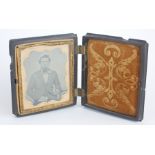 A 19TH CENTURY DAGUERREOTYPE, PORTRAIT OF A GENTLEMAN Cartouche yellow metal mount, in folding