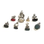 A COLLECTION OF SIX VICTORIAN AND LATER WHITE METAL AND HARDSTONE WATCH FOBS Each set with agate