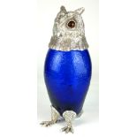 A SILVER PLATE AND BRISTOL BLUE GLASS CARAFE IN THE FORM OF AN OWL WITH AMBER GLASS EYES. (28cm)