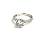 AN 18CT WHITE GOLD AND 1.72CT DIAMOND RING Having a central round cut stone, with diamond set