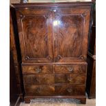 A 19TH CENTURY MAHOGANY LINEN PRESS With stepped cornice above two panelled doors enclosing slides