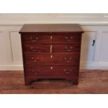 A GEORGIAN MAHOGANY CHEST Of four long graduating drawers fitted with brass swan neck handles and