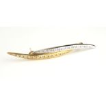A 14CT BICOLOUR GOLD AND DIAMOND BROOCH The row of round cut diamonds in a crossover design. (approx