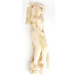 AN ART DECO PERIOD IVORY STATUE, SEMICLAD MAIDEN IN EGYPTAN DRESS. (23cm) Condition: good throughout