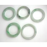 A COLLECTION OF FIVE CHINESE JADE BANGLES Spherical form of lain design. (approx overall diameter