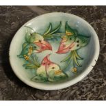 MOORCROFT, A VINTAGE TUBE LINED POTTERY PLATE Floral decoration, pressed marks to base and