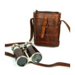 AN EARLY 20TH CENTURY OF CROCODILE SKIN BINOCULARS Twin lenses with telescopic mechanism and outer