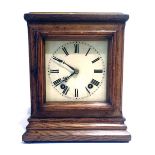 A 1920'S OAK CASED MANTEL CLOCK With eight day movement, white enamel dial and Roman numerals. (h