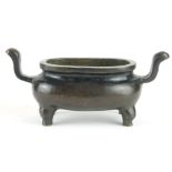 A CHINESE BRONZE CENSER Having twin handles and raised on four legs, bearing a cast Xuande 1425 -