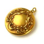 A 14CT GOLD CIRCULAR VICTORIAN DESIGN LOCKET With relief floral cartouche. (3cm) Condition: good