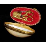 A 19TH CENTURY GILT METAL AND MOTHER OF PEARL MINIATURE OVAL SEWING NÉCESSAIRE CASE With gilt