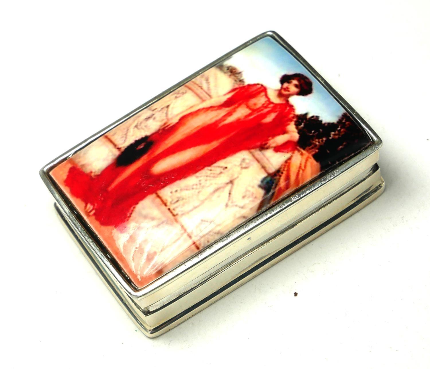 A SILVER AND ENAMEL 'CLASSICAL MAIDEN' RECTANGULAR PILL BOX With enamel Maiden to hinged lid. (