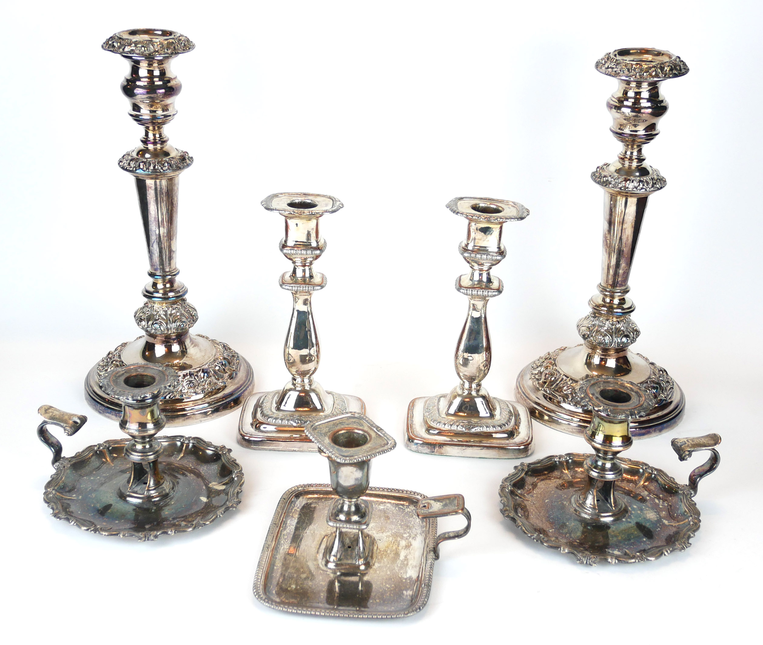 A COLLECTION OF 19TH CENTURY AND LATER SILVER PLATE ON COPPER CANDLESTICKS, A pair with embossed