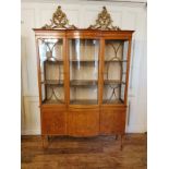 A SHERATON REVIVAL SATINWOOD AND MARQUETRY INLAID DISPLAY CABINET The convex glazed central