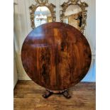 A REGENCY PERIOD FLAME MAHOGANY CIRCULAR BREAKFAST TABLE Raised on a single fluted column standing