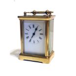 AN EARLY 20TH CENTURY BRASS CASED CARRIAGE CLOCK Having four section bevelled glass panels, white
